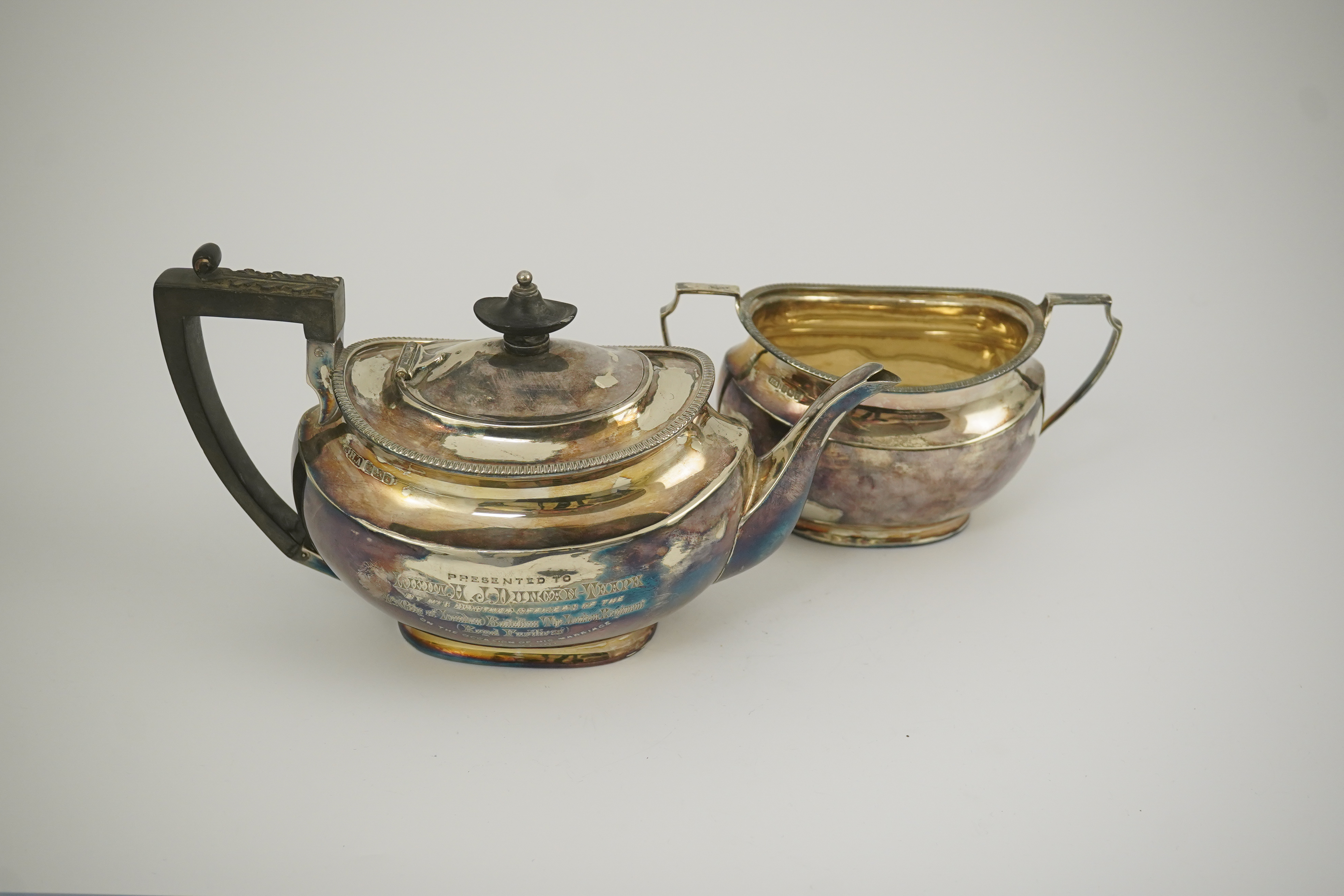 An Edwardian silver teapot and a matching sugar bowl, with engraved inscription, relating to the Royal Fusiliers, by Atkin Brothers